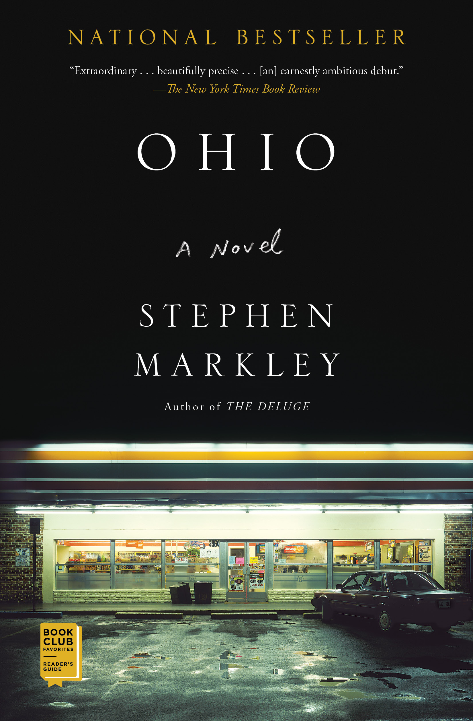 Moody photographic cover showing a brightly lit convenience store at night with a parked car in front. Large black space above contains the title “Ohio” and the author’s name, Stephen Markley.