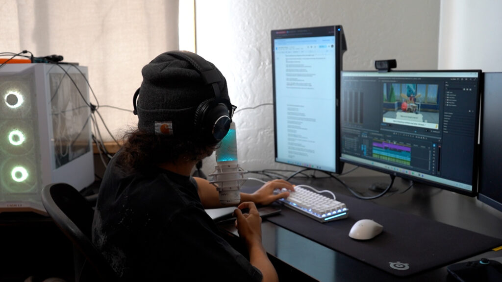 A person sitting at a computer indoors.