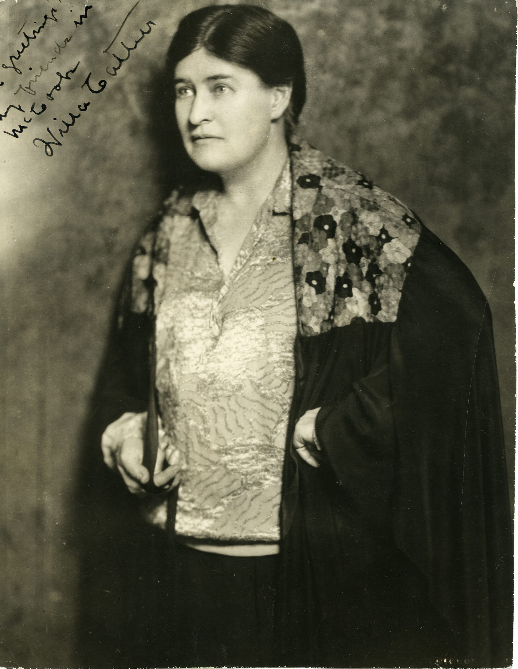 Black-and-white portrait of author Willa Cather wearing a patterned blouse and shawl, facing slightly to the side.