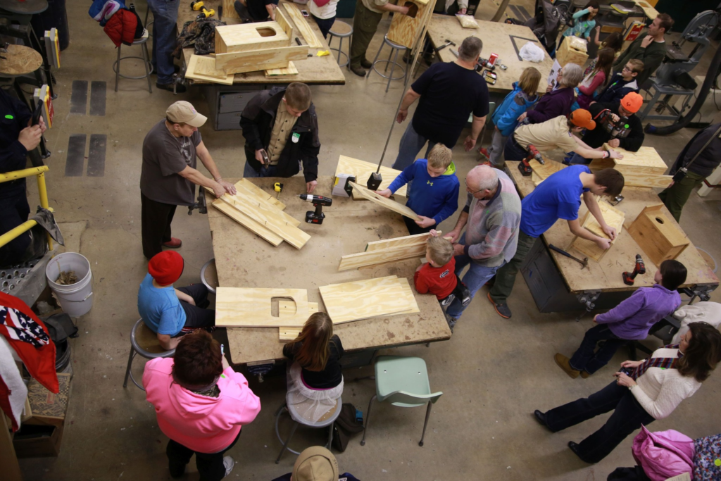 An overhead look of people working with wood.